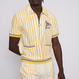 A person wearing a yellow and white striped shirt