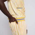 A person wearing a yellow and white striped shirt