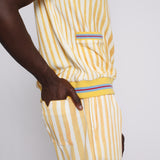 A person wearing a yellow and white striped shirt