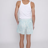 Male model looking over his shoulder in trunks with a white tank