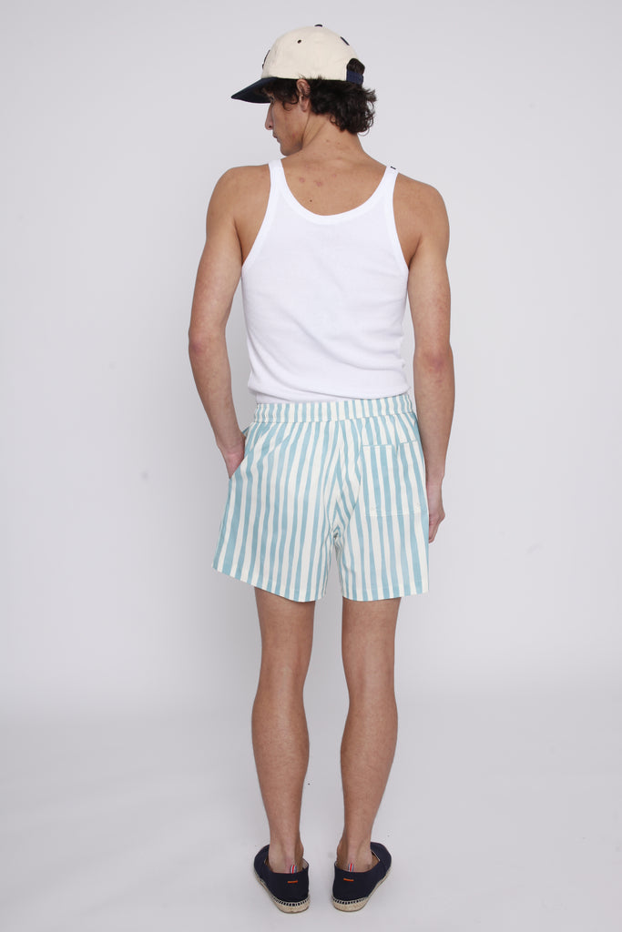 Male model looking over his shoulder in trunks with a white tank