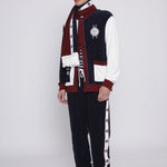 Male model in full set also wearing a white beanie and boots