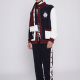 Male model in full set also wearing a white beanie and boots