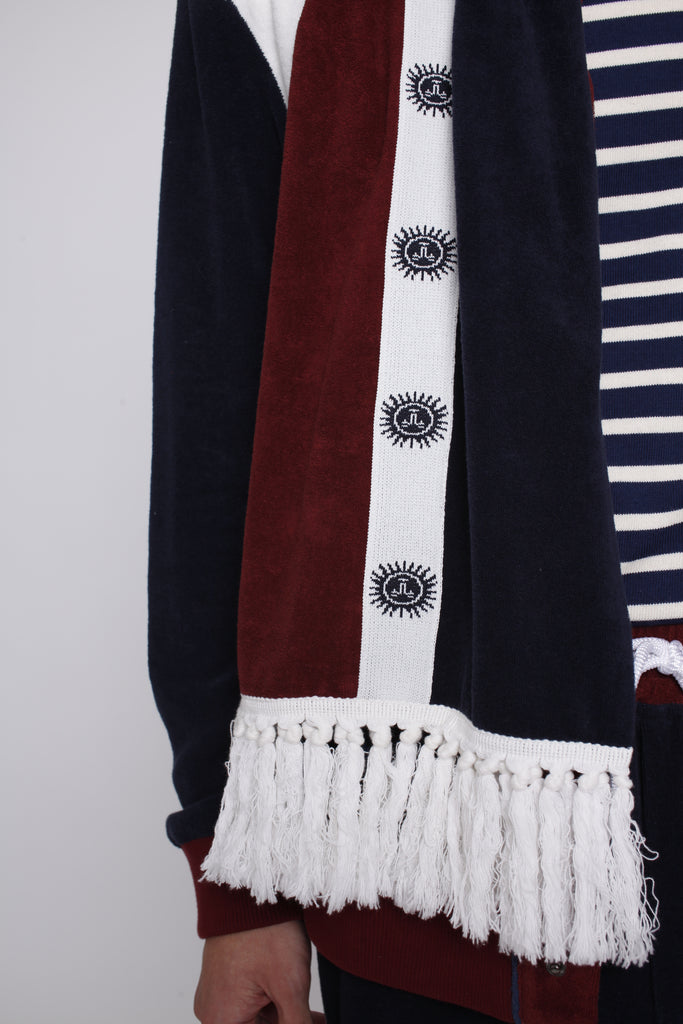 male model close up of fringe white fabric on bottom of scarf