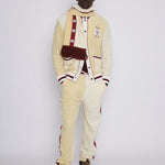 Male model in full set gazing at camera in photo studio