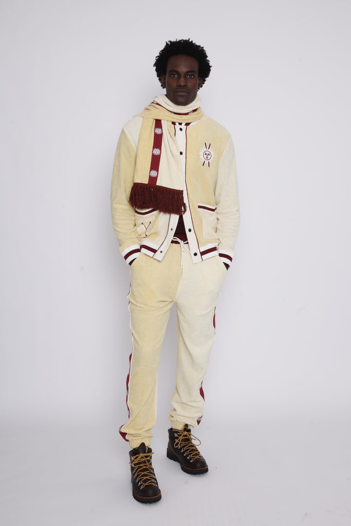 Male model in full set including scarf standing with left food forward