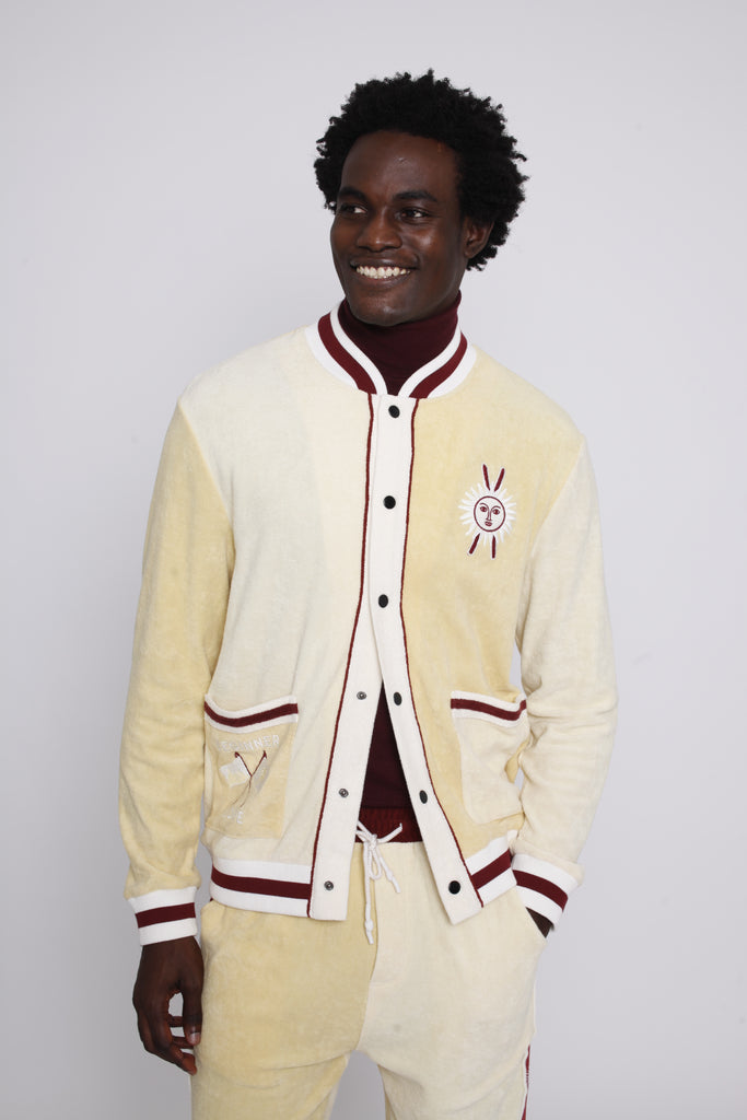 Male model smiling in cabana top with bottom three buttons undone