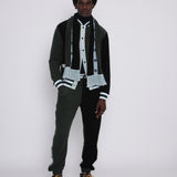 male model demonstrating how you can match it with the terry cloth pants and scarf for the complete beginner skier look