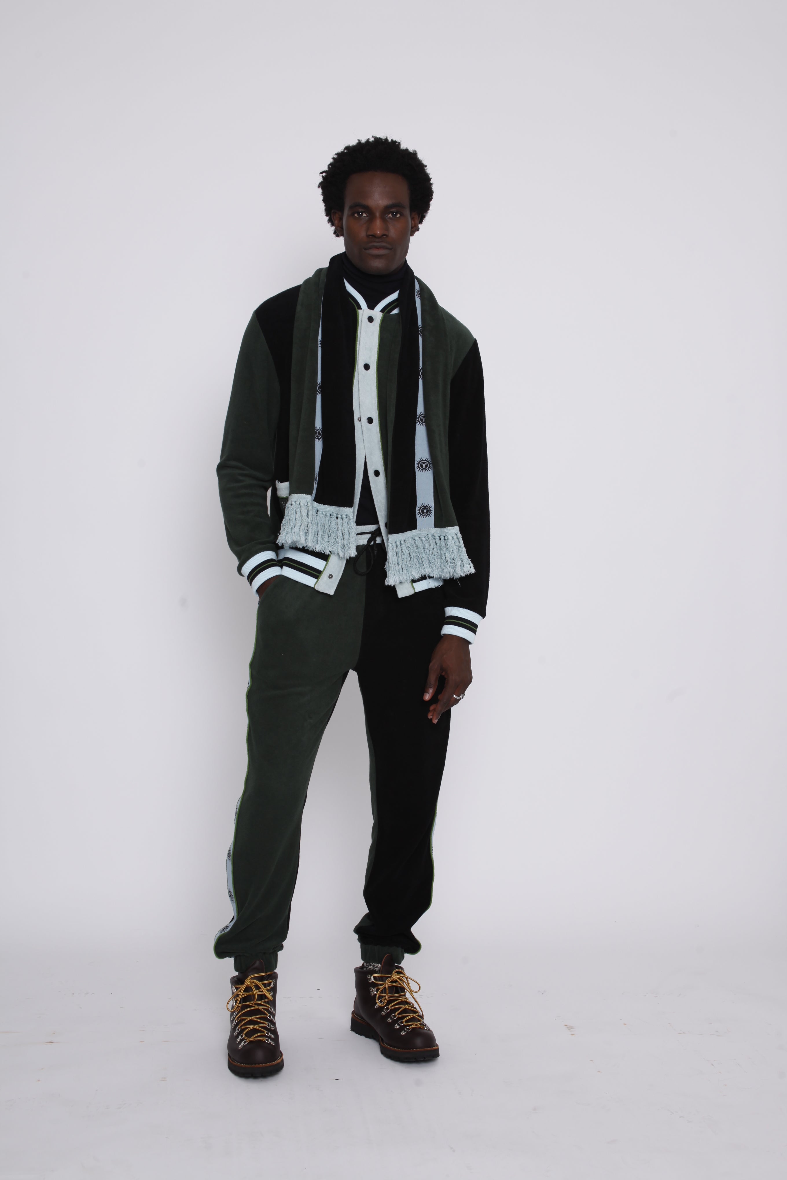 male model posing in studio in full après ski scarf set