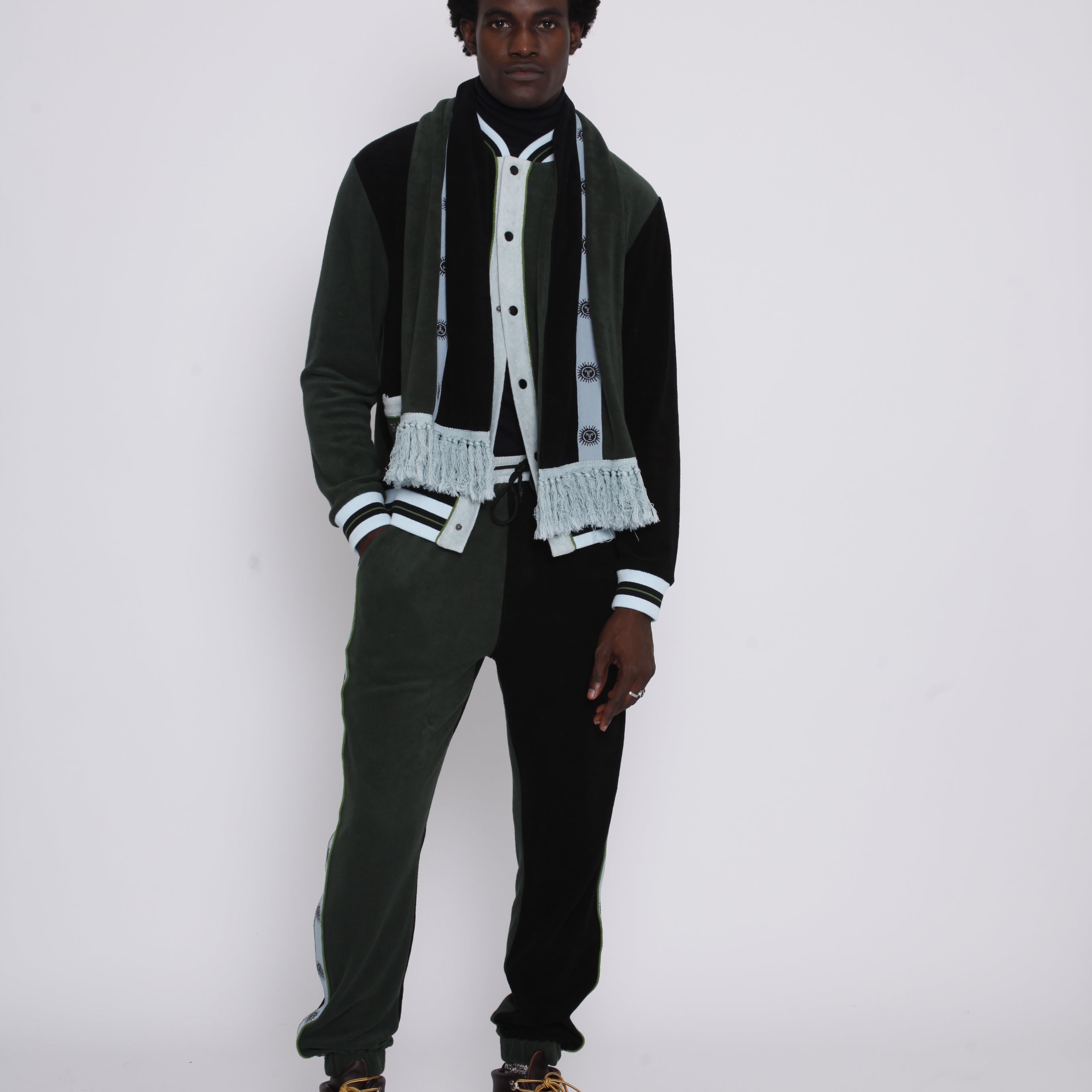 Male model with hand in pants pocket gazing at camera