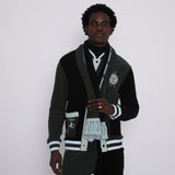 male model gazing at camera in full après ski green set including scarf