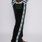 male model standing in full green apres ski set with hand in back pocket