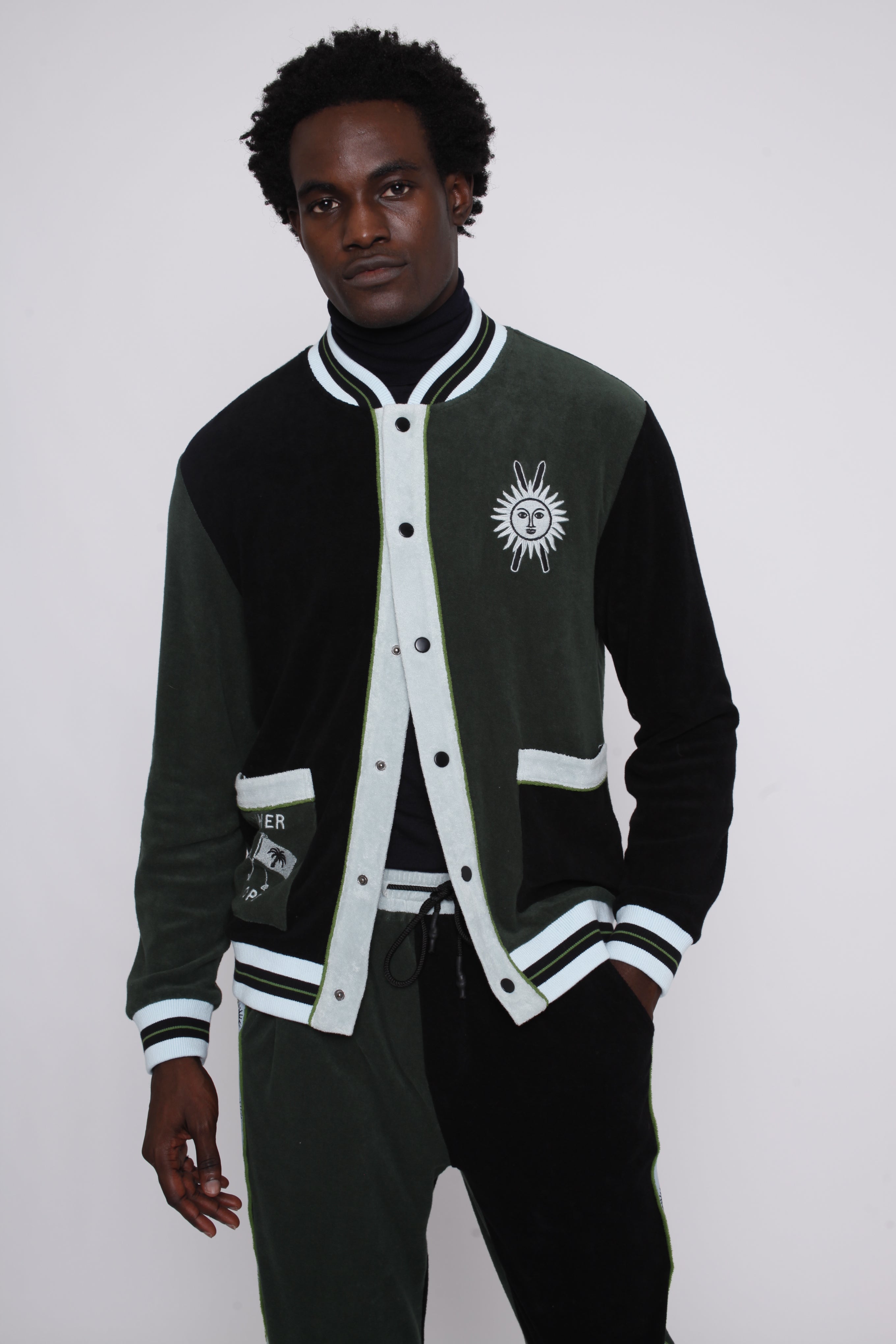 male model posing in this partially unbuttoned long sleeve terry cloth cabana shirt for stylish skiers