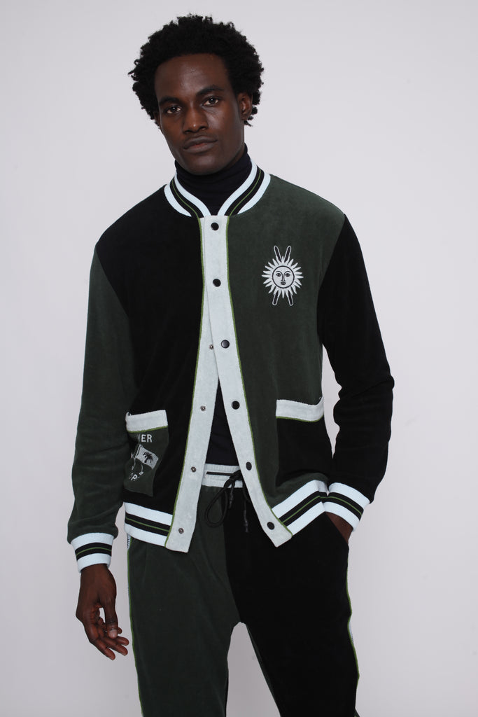 male model posing in this partially unbuttoned long sleeve terry cloth cabana shirt for stylish skiers