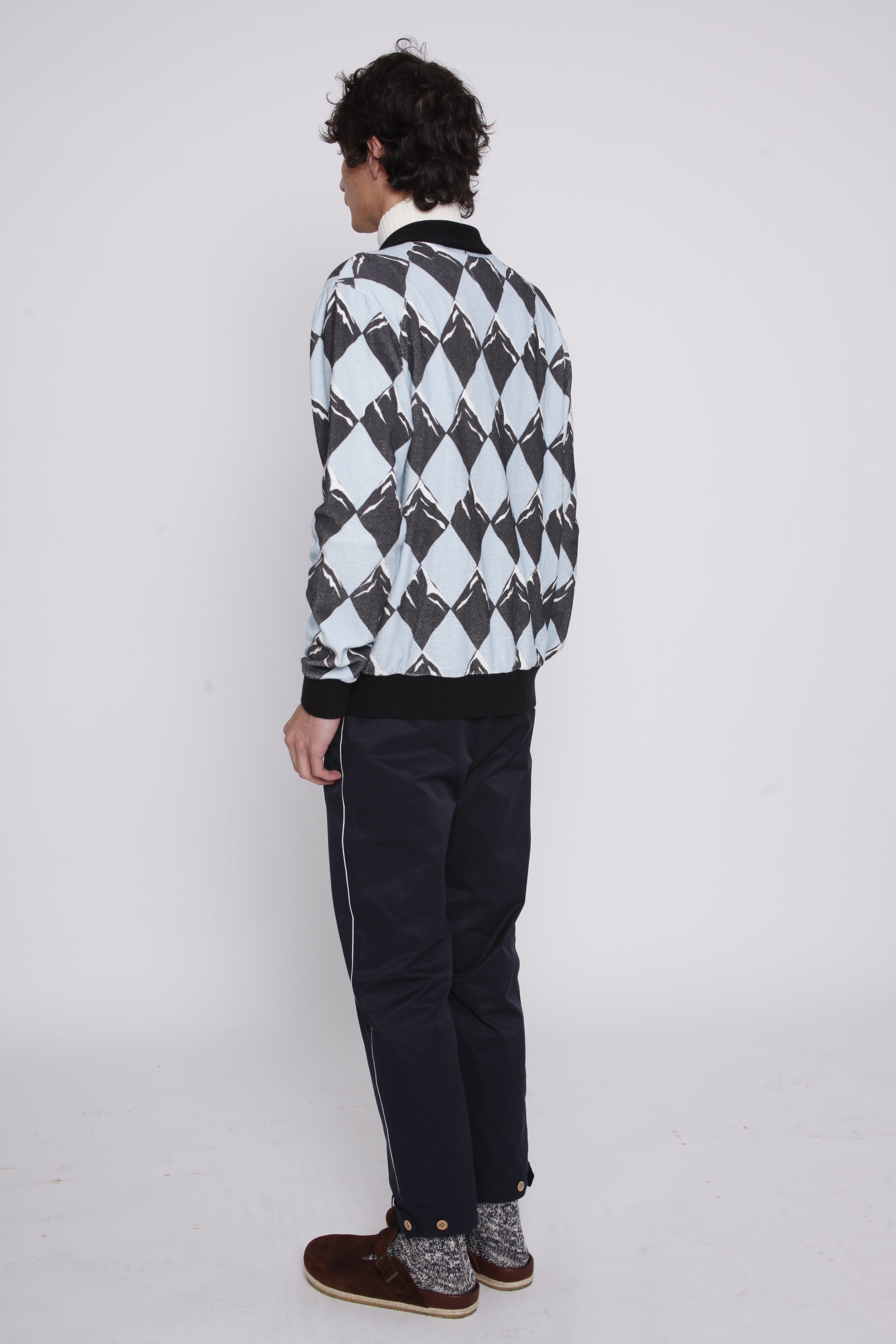 Back view of male model in same outfit now showing his birkenstock boston clogs