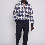 male model posing in cabana with navy pants