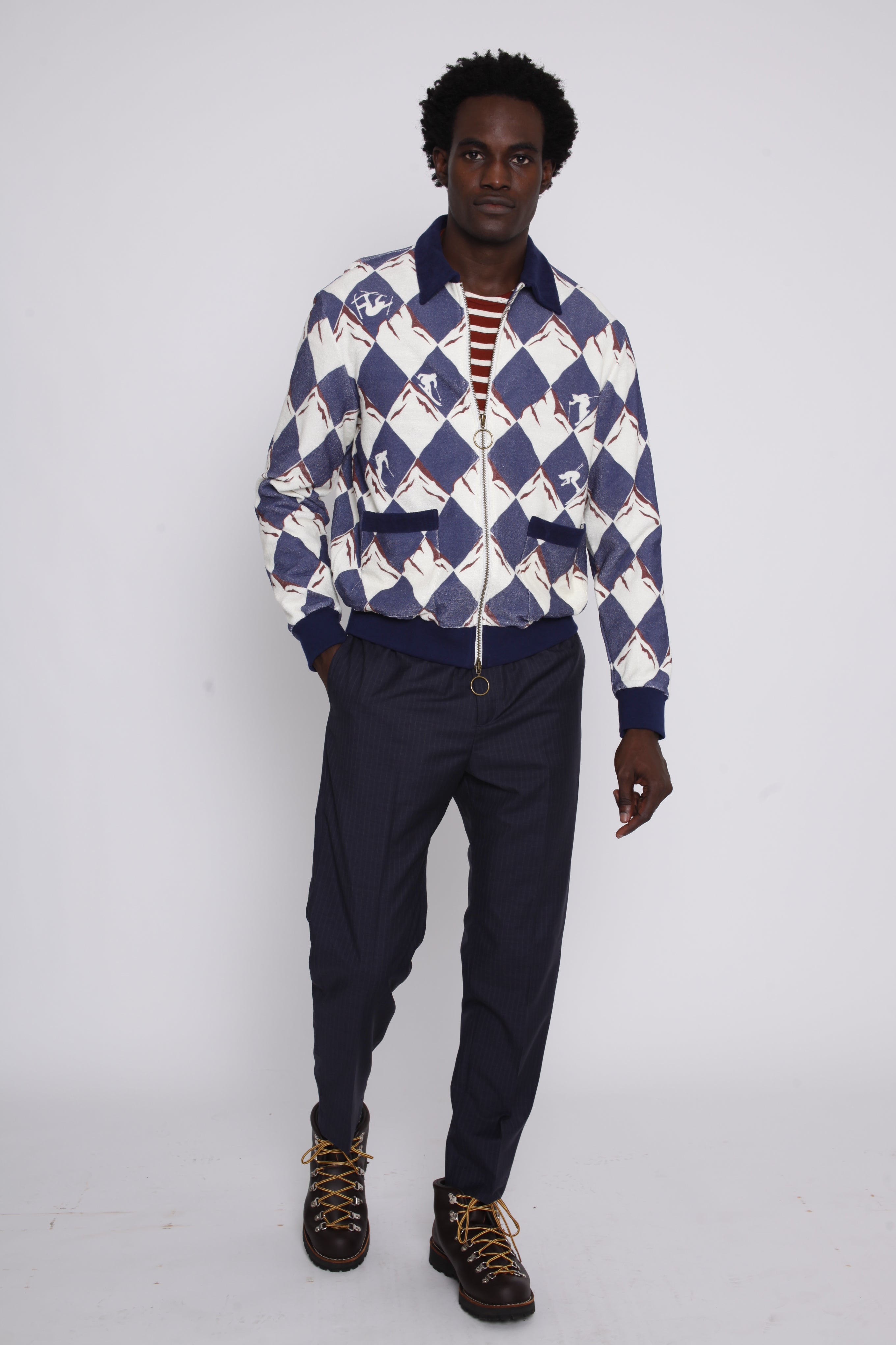 male model posing in cabana with navy pants