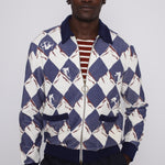 front view of male model in cabana half unzipped over a maroon and white striped tee