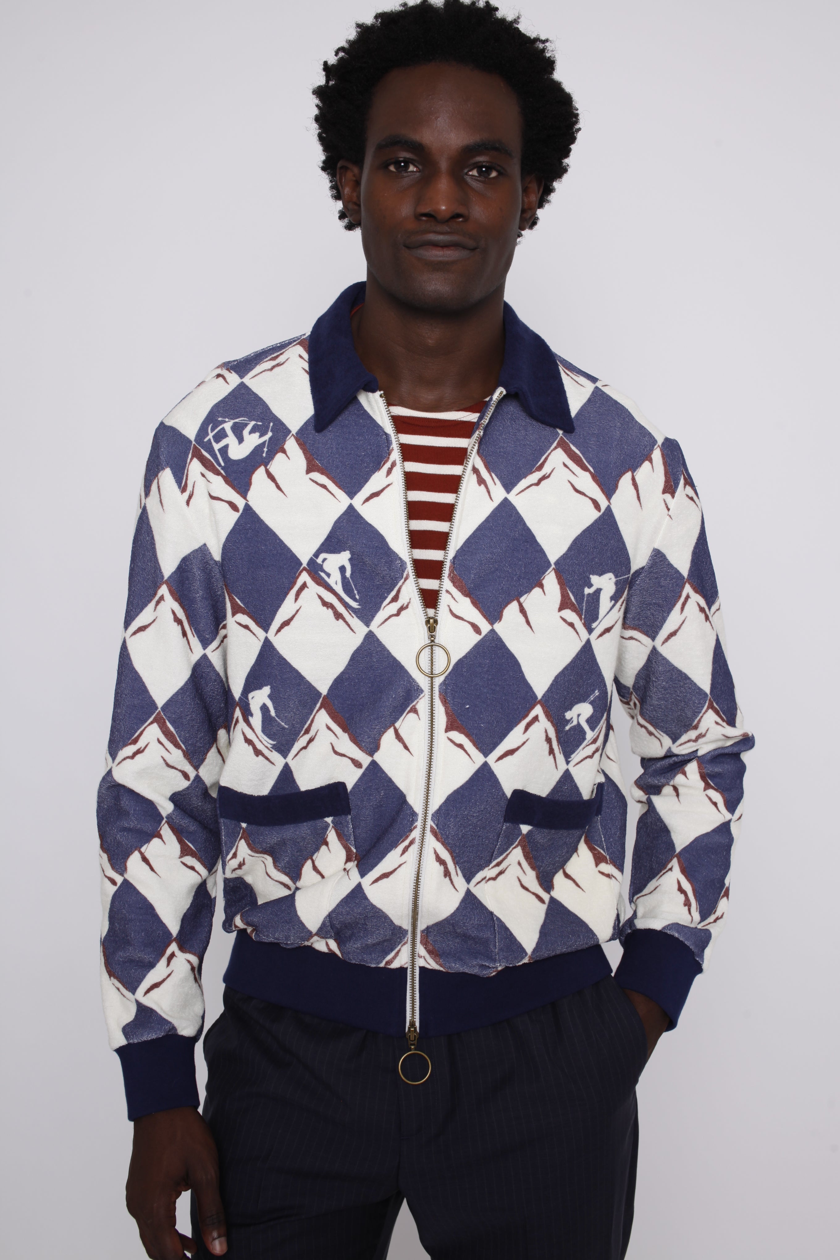 front view of male model in cabana half unzipped over a maroon and white striped tee
