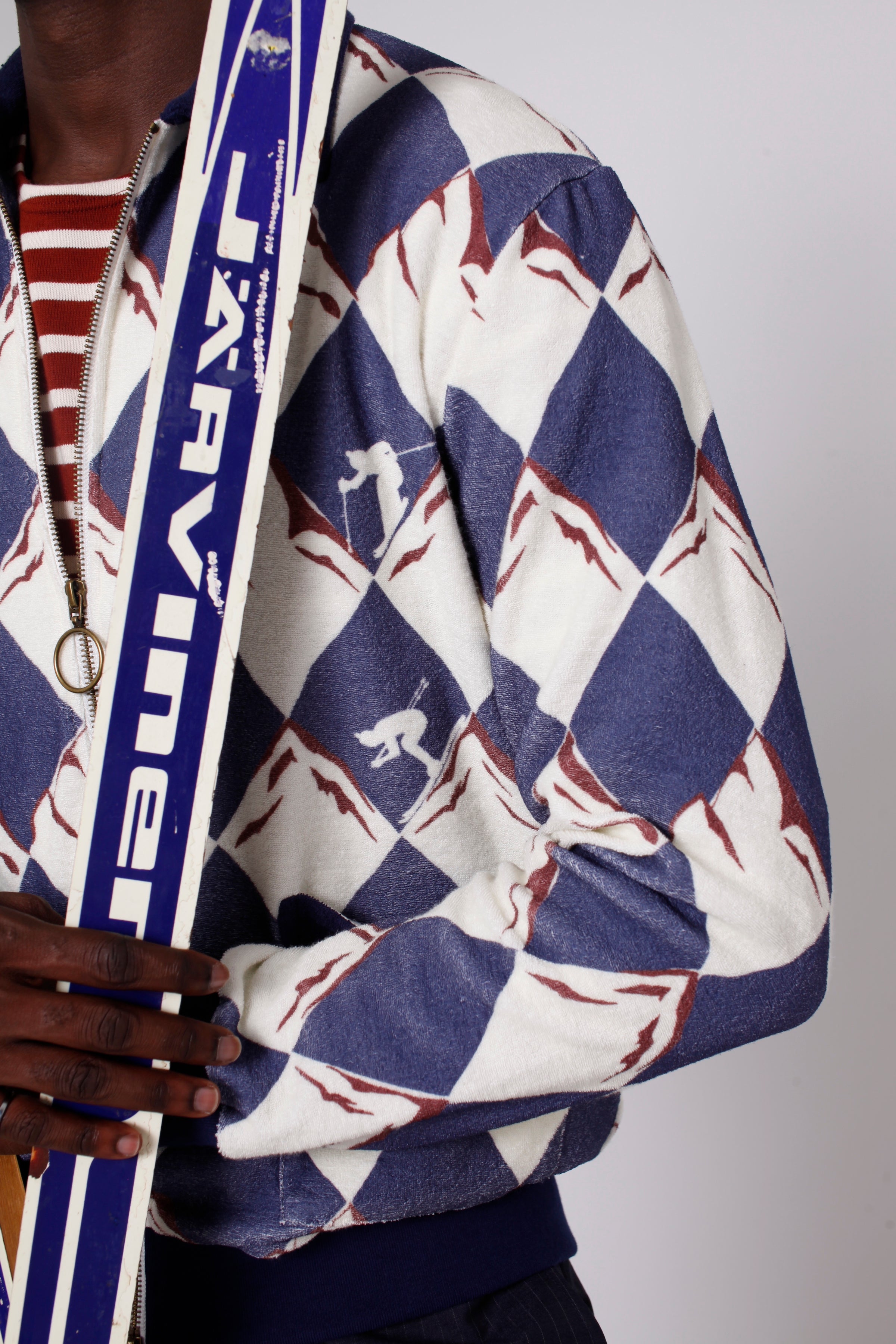 close up of maroon detailing on the diamond alp print