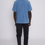 Back view of blue polo on male model 