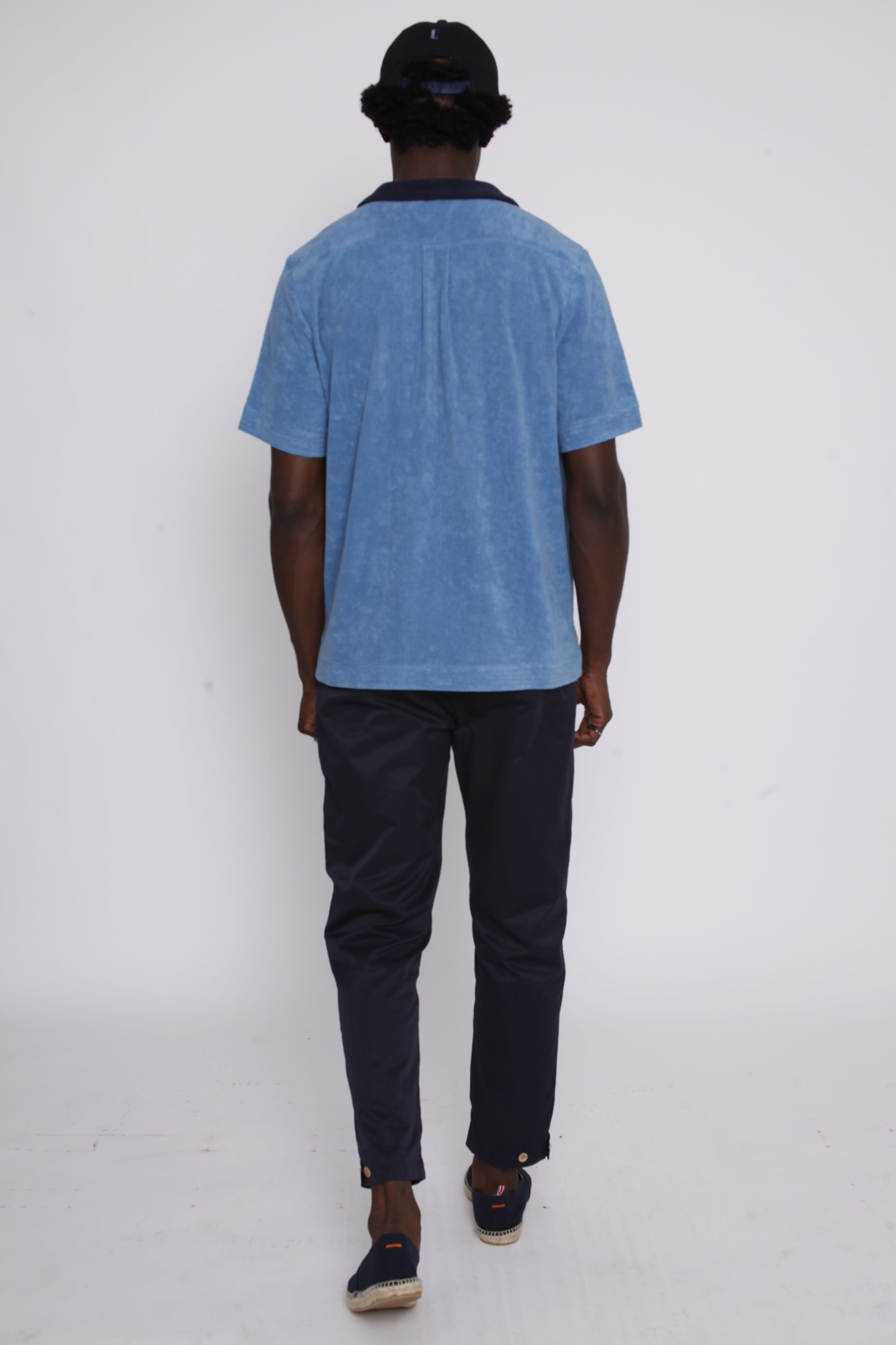 Back view of blue polo on male model 