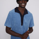 Male model wearing blue polo smiling