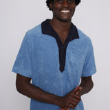 Male model wearing blue polo smiling