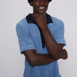 Male model posing in polo with hand under chin