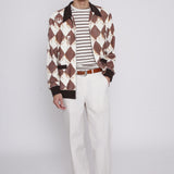 Man with hand in pocket and unbuttoned Black Diamond Cabana stares at camera