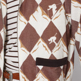 Close up of unzipped jacket showing skier motifs and pocket with black top lining