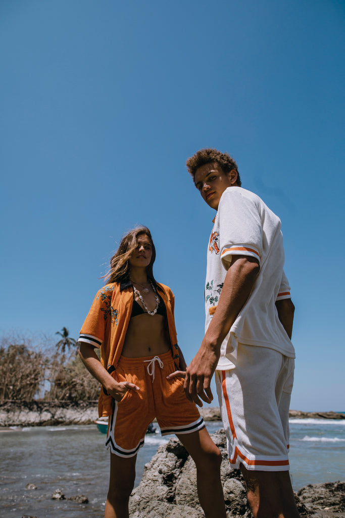 Male and female models both wearing full sets at the beach
