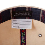 Inside tag of hat saying 100 percent organic cotton exclusive of decoration