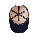 Inner view of cap showing floral emblems and striped inner lining