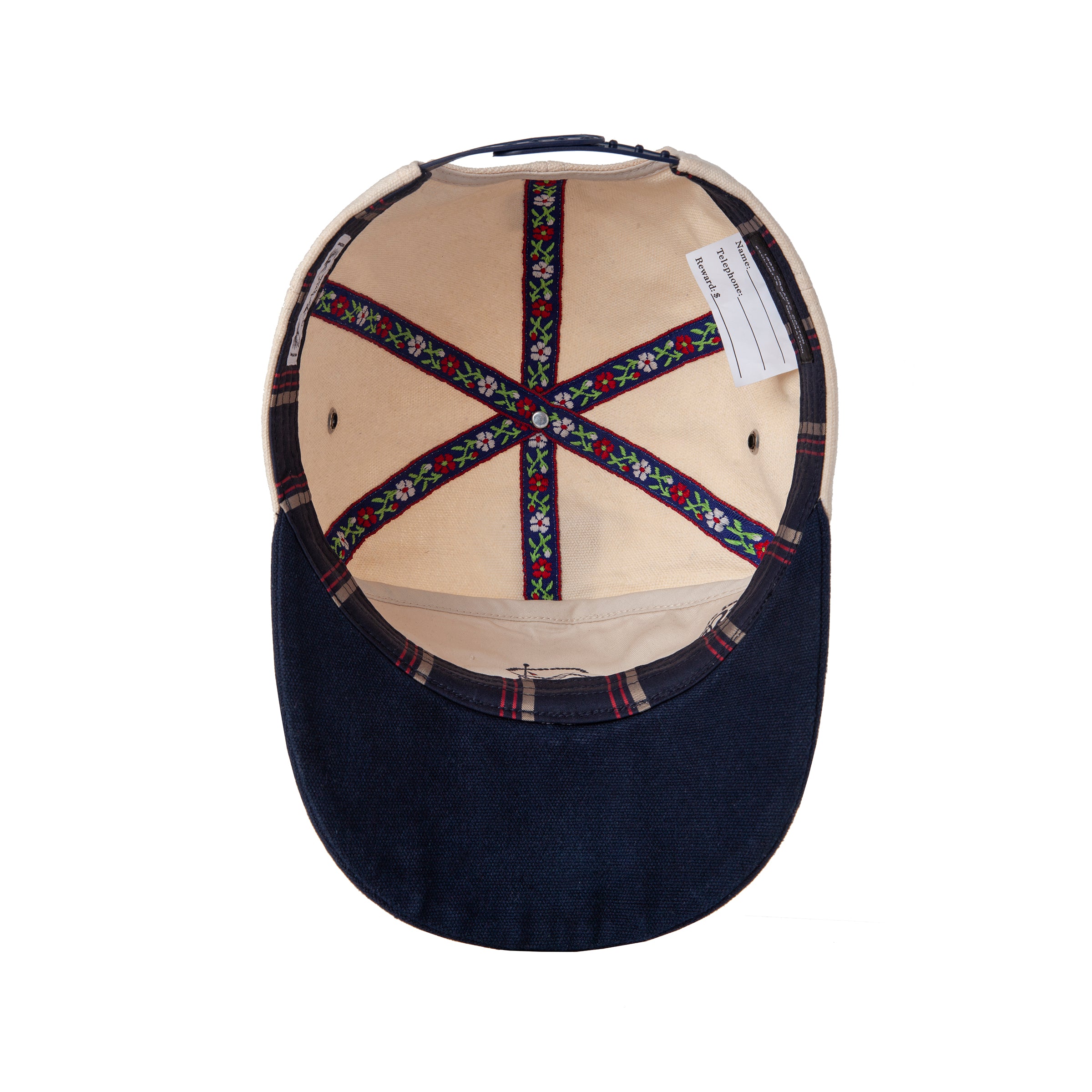 Inner view of cap showing floral emblems and striped inner lining