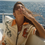Woman blowing a kiss on a boat, wearing the 'Crouching Tiger' Cabana.