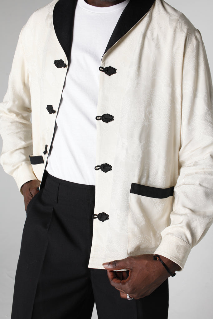 Close up of mid body showing unbuttoned no smoking jacket