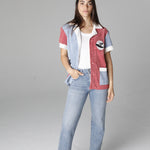 Female model posing in cabana open over a white tee and light wash jeans