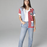 Female model posing in cabana open over a white tee and light wash jeans