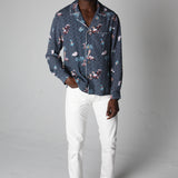 male model wearing top with white pants in a photo studio