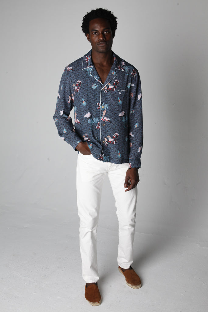 male model wearing top with white pants in a photo studio