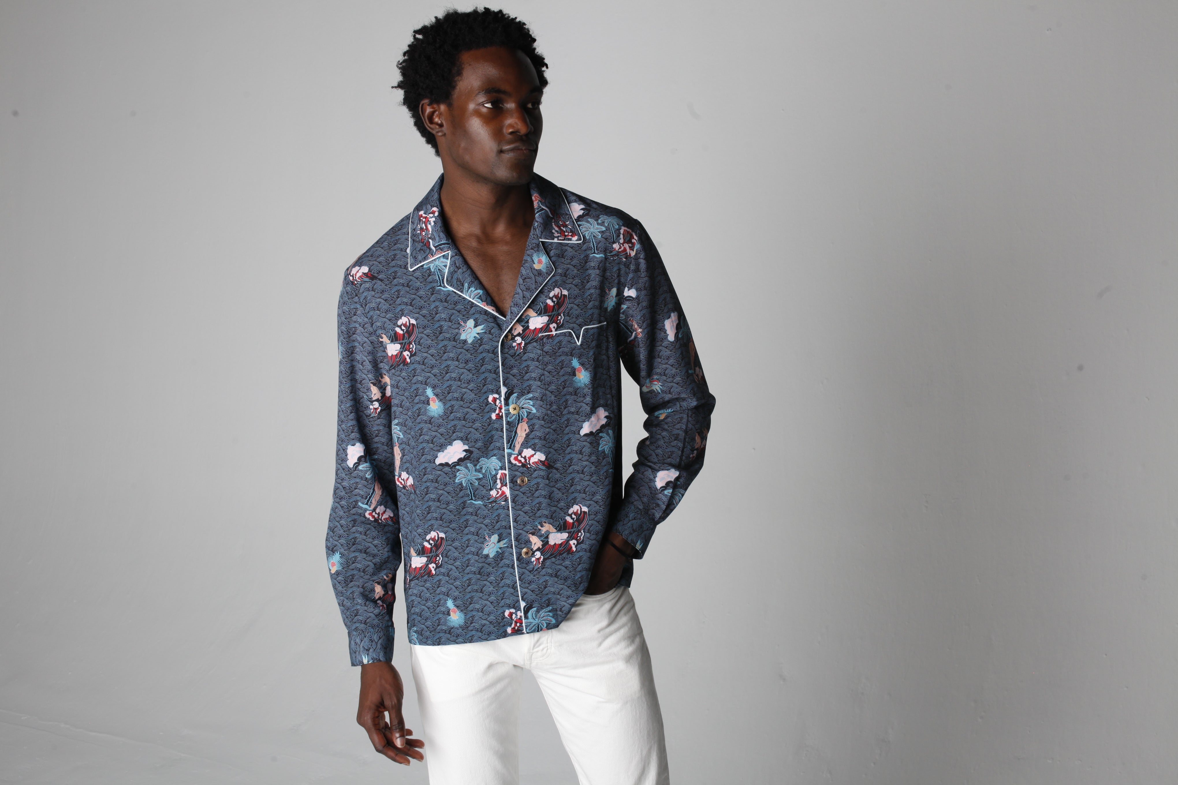 male model posing in top with right hand in his pocket
