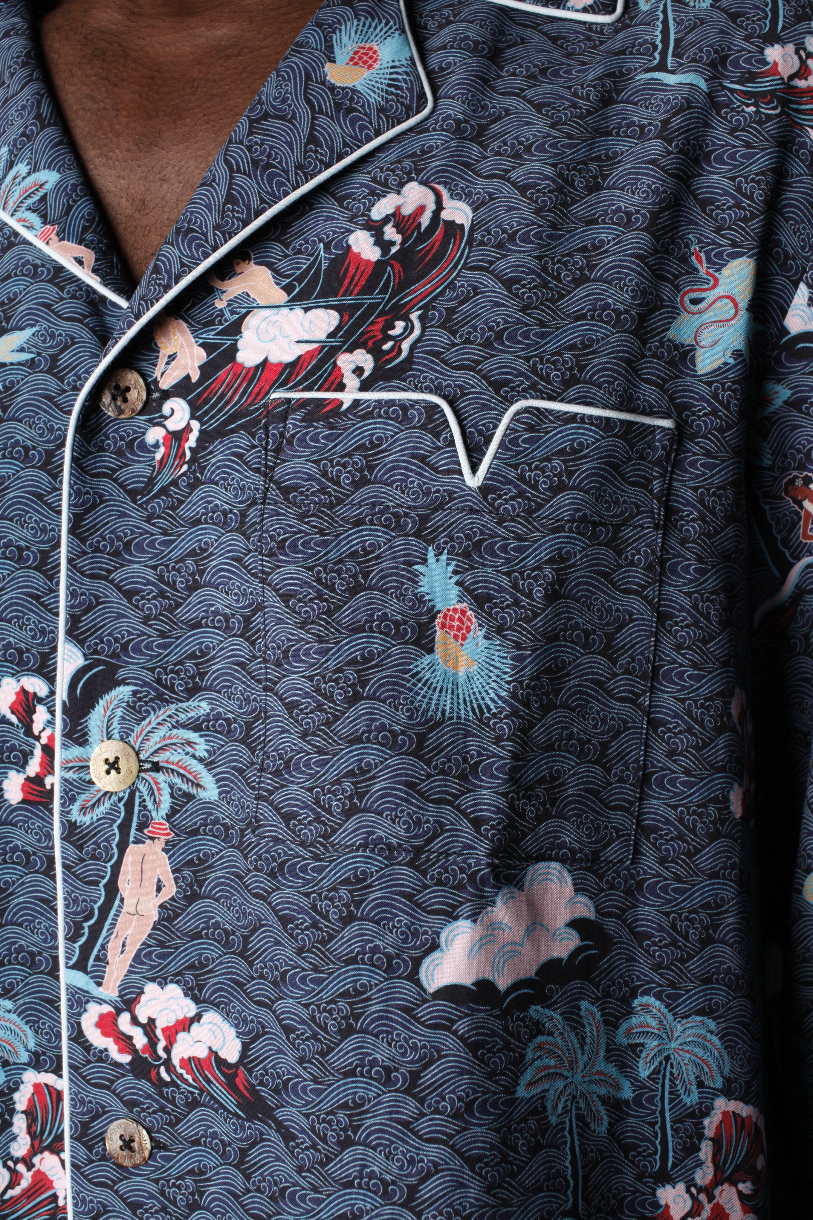 close up view of pocket with light blue piping