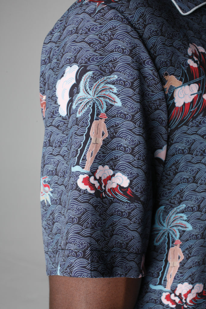 Close up of left sleeve showing the print with a naked backside Adam leaning on a palm tree