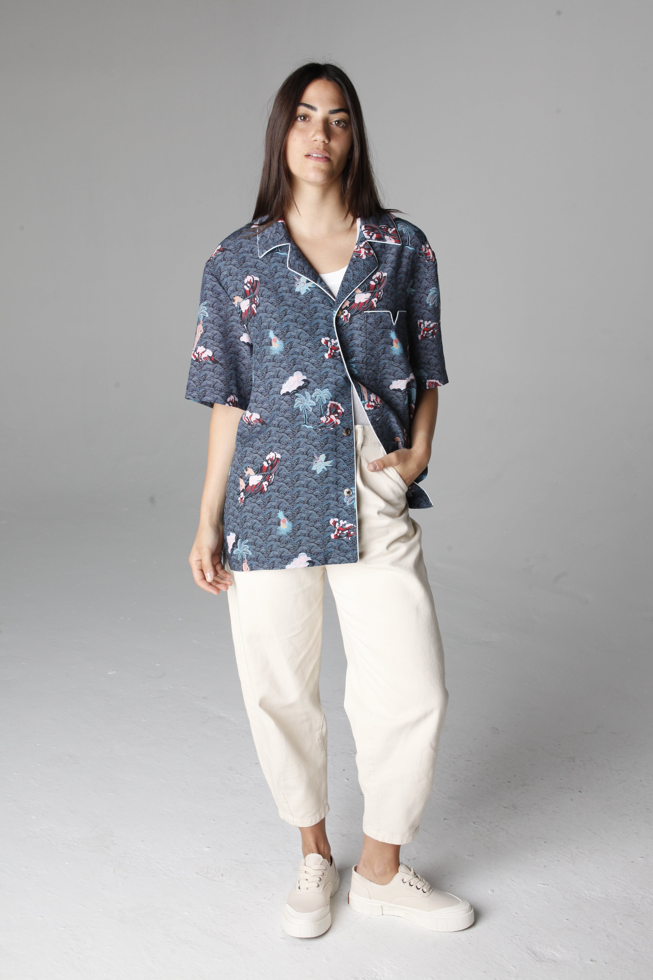 Female model looking at camera with hand in right pants pocket