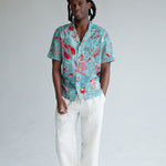 male model wearing top with white pants and shoes