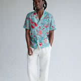 male model wearing top with white pants and shoes