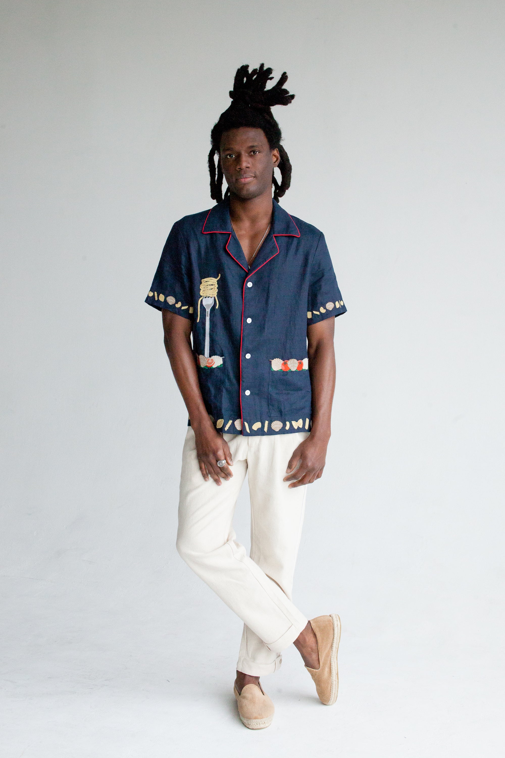 Male model wearing the shirt with white pants