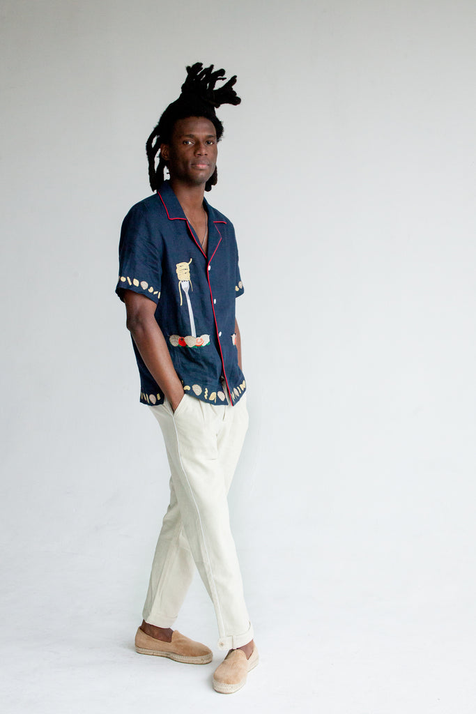 Male model wearing shirt in studio with white pants