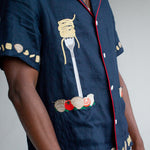 Close up of left side of shirt on a male model in a studio